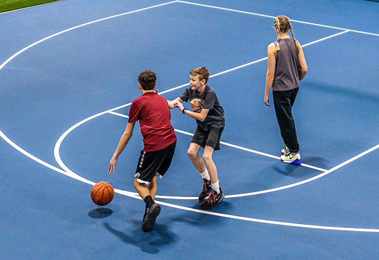 kids playing basketball at gym