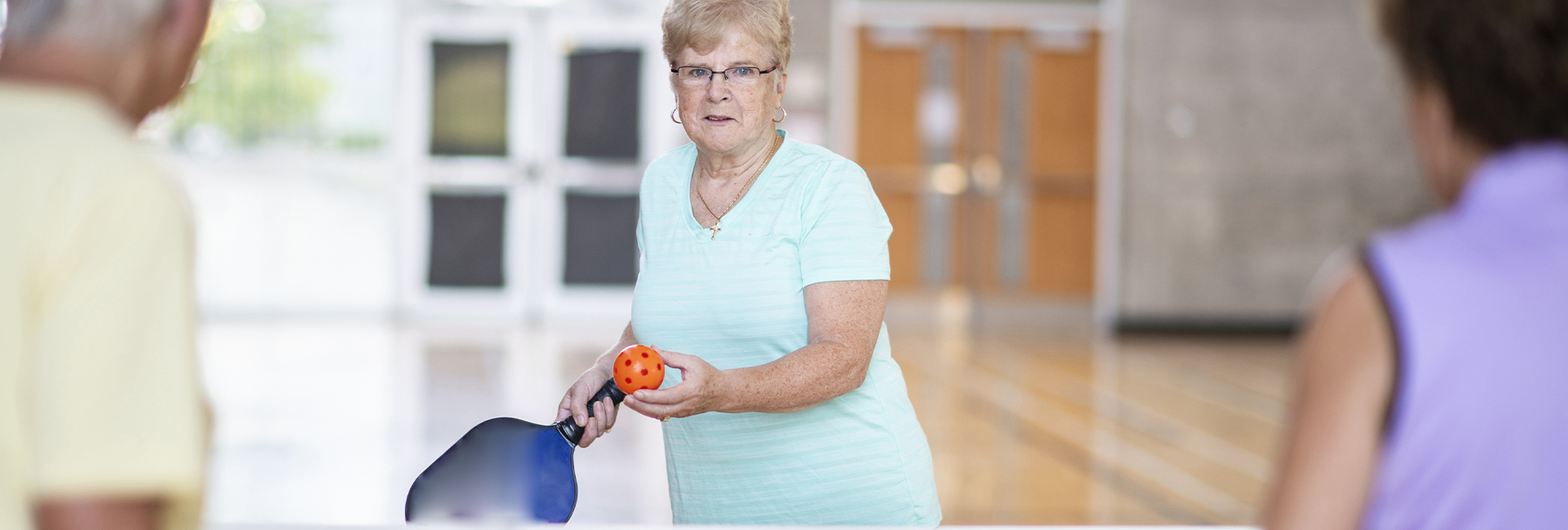 older people playing pickleball
